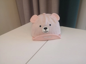 Detail of pink striped baby sun hat with cute 3D bear ears and embroidered nose