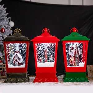 Three decorative Christmas snow globes lanterns with rotating scenes and falling snow