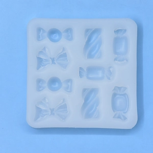 White silicone candy mold with 8 cavities for chocolate and mousse on blue background