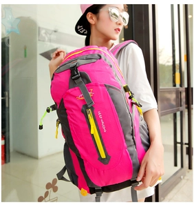 Detailed side view of pink outdoor backpack with mesh pocket and yellow cords