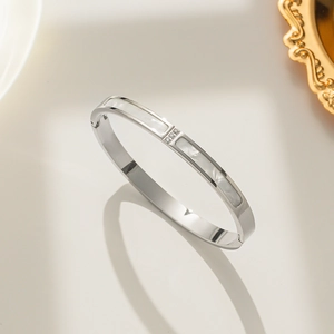 Minimalist silver bangle featuring white shell inlay and three centered crystals inlay