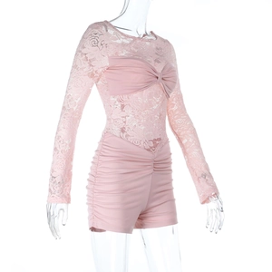 Detailed view of pink lace patchwork sleeves and ruched hem on a stylish romper