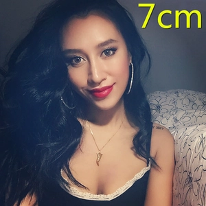Model wearing oversized 7cm crystal studded hoop earrings in gold finish for women