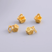 Detailed view of four golden S925 sterling silver auspicious charms for DIY bracelets