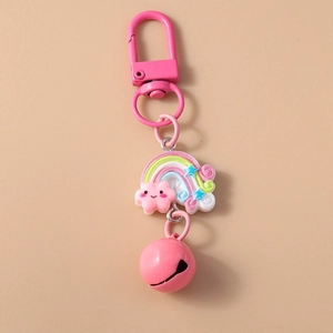 Detail of pink keychain featuring rainbow cloud charm and small jingling metal bell