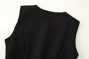 Close-up of neckline stitching and shoulder detail on a black sleeveless dress
