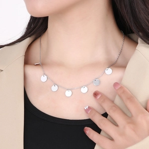 Close-up of a silver stainless steel necklace with multiple small round disc pendants