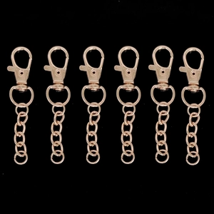 Detailed view of rose gold alloy lobster clasps with extender chains for DIY keychains