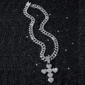 Silver iced out hip hop cross pendant with hearts on a sparkling cuban link chain