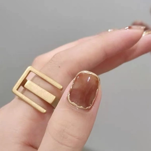 Retro geometric matte gold open ring set with amber brown resin stone on hand
