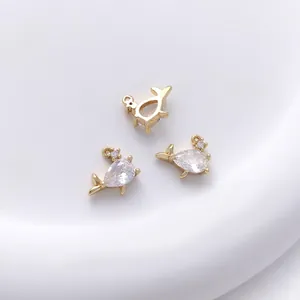 Detailed view of 14K gold whale pendants with teardrop zircons for DIY jewelry