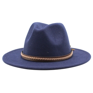 Detail of navy blue wool fedora with brown braided leather band on white background