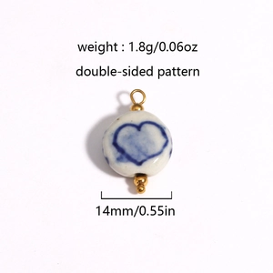 Detail view of a 14mm ceramic bead with blue heart pattern and 18K gold plating