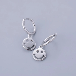 Macro shot of S925 sterling silver hoop earrings with hollow smiley face pendants