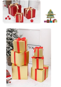 Detail of Christmas gift box set with gold ribbon and festive decor in snow scene