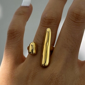 Detail of minimalist gold-finish geometric open ring with polished asymmetric oval shapes
