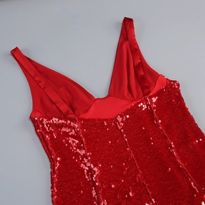 Detail of red sequin evening gown showing V-neckline and smooth satin shoulder straps