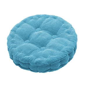 Detail of blue corduroy round cushion showing plush texture and quilted button design