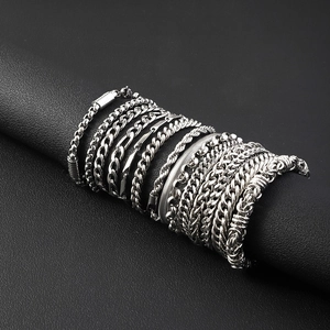 Various silver stainless steel Cuban and snake chains on a black display stand