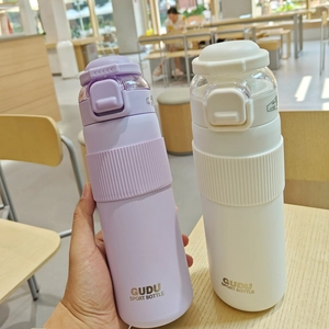 Detail of purple and ivory sports water bottles with matte texture and silicone grip