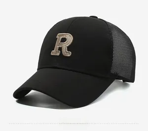 Detail of embroidered beige letter R on black mesh baseball cap with side view