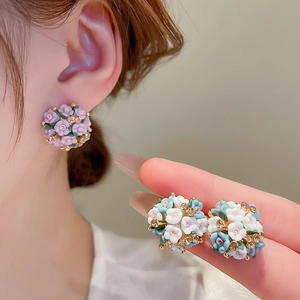 Detailed view of handmade ceramic flower cluster earrings with sparkling rhinestones