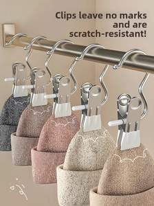 Detail of stainless steel clips with white anti-slip pads holding a beige knit hat
