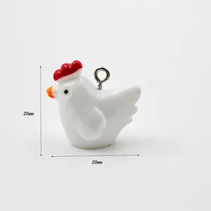 Detail view of a 20mm white rooster acrylic pendant with red comb for DIY jewelry making