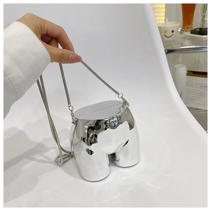 Close-up of avant-garde silver mirror finish female torso shaped acrylic mini clutch bag