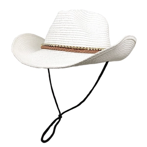 Detail of white woven straw cowboy hat with decorative beaded band and windproof cord