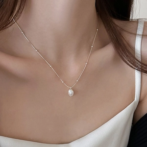 Elegant stainless steel necklace with a white baroque pearl pendant on a beaded chain