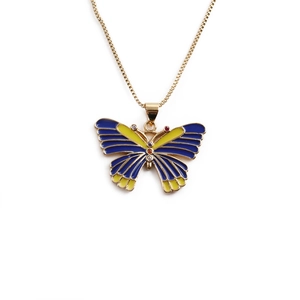 Vintage gold butterfly pendant necklace with blue and yellow enamel wings on white background