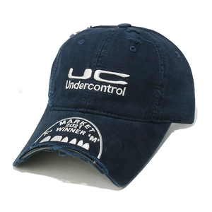 Detailed embroidery on distressed navy canvas baseball cap with vintage worn-out finish