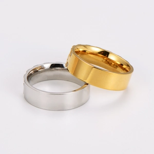 Polished gold and silver stainless steel square sugar rings stacked on white background