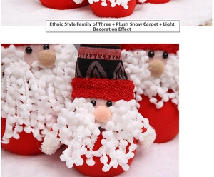 Close-up of ethnic style plush Santa set on a soft white faux fur snow carpet