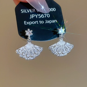 Macro shot of silver fan earrings featuring micro-set zircon stones on a s925 silver base