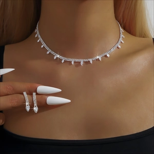Detail of silver rhinestone fringe necklace and long tassel earrings on a bride