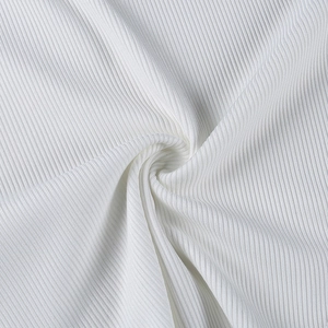 Close-up of premium white ribbed knit fabric showing soft texture and vertical patterns