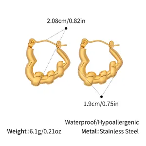 Detailed view of gold twisted heart earrings with dimensions 1.9cm and 2.08cm