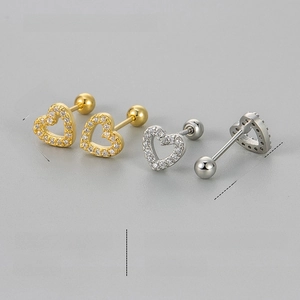 Macro view of crystal hollow heart ear studs in gold and silver finish with ball screw back