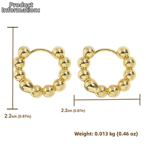 Detail view of gold beaded hoop earrings with 2.2cm diameter and 13g weight specs
