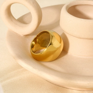 Minimalist 18K gold plated chunky spherical stainless steel ring on a ceramic base