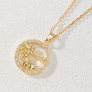 Golden Mama pendant necklace with zircons and children's silhouette on white background