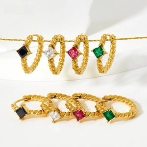 Detail of four pairs of vintage twisted gold hoop earrings with colorful square gemstones