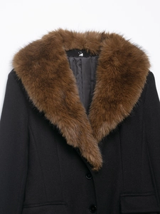 Detail of premium wool blend coat featuring a luxurious brown faux fur collar and black fabric