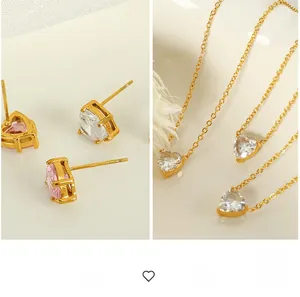 Detailed macro shot of heart-shaped zircon jewelry set with gold plating and fine chains