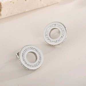Detailed close-up of silver round hollow stud earrings with micro-pave white rhinestones