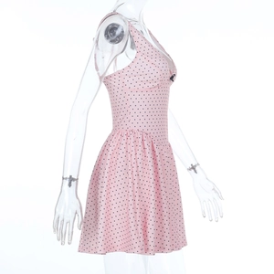 Detail of pink polka dot dress showing high-quality fabric texture and refined stitching