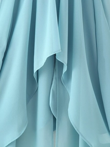 Close-up detail of light blue chiffon fabric showing soft pleats and fine edge stitching