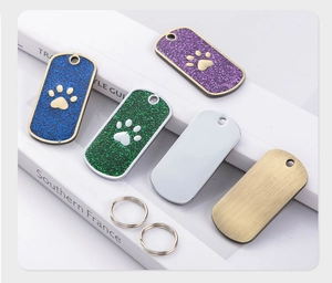 Glittery dog tag charms in multiple colors with paw prints and metal ring attachments